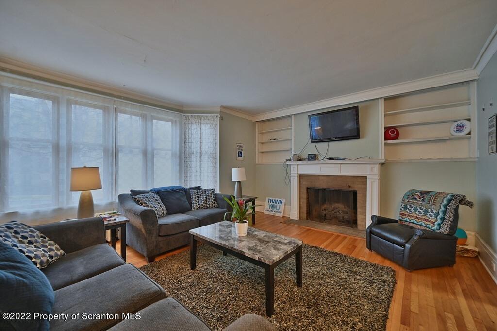 811 Olive Street Scranton, PA 18510 - Photo 11 of 54 a living room with furniture and a fireplace