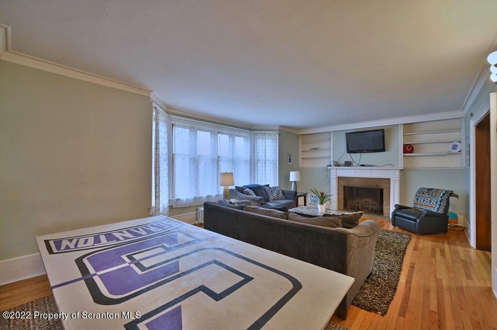 811 Olive Street Scranton, PA 18510 - Photo 13 of 54 a bedroom with furniture and a fireplace