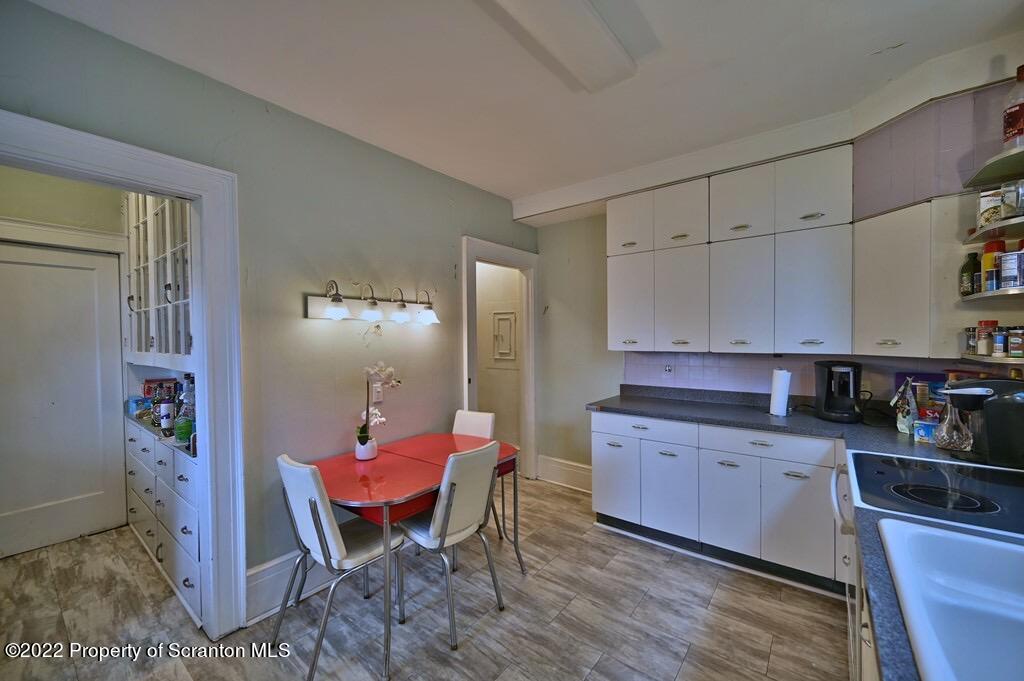 811 Olive Street Scranton, PA 18510 - Photo 16 of 54 a kitchen with granite countertop a sink cabinets and stove top oven