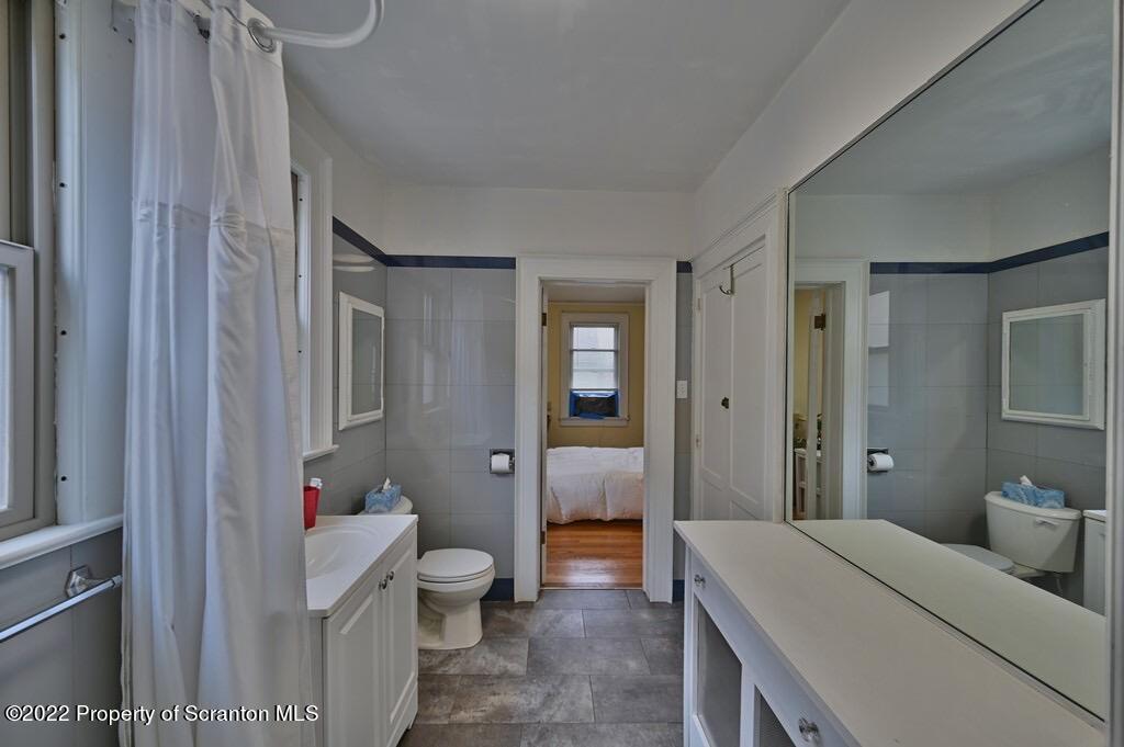 811 Olive Street Scranton, PA 18510 - Photo 27 of 54 a bathroom with a granite countertop sink a toilet and shower