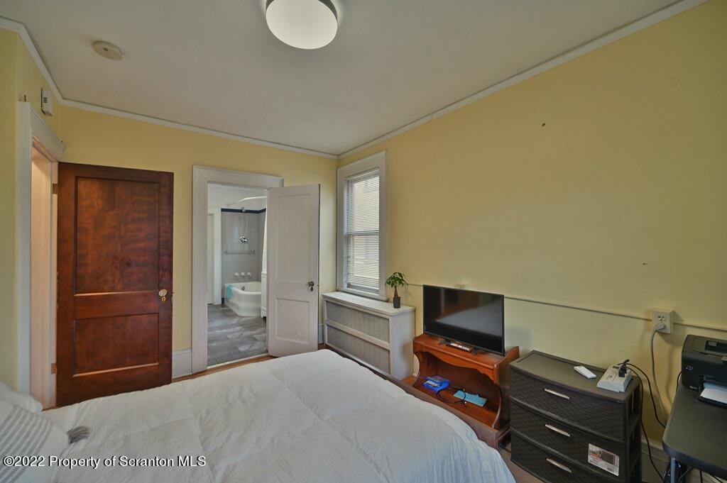 811 Olive Street Scranton, PA 18510 - Photo 29 of 54 a bedroom with a bed and a television