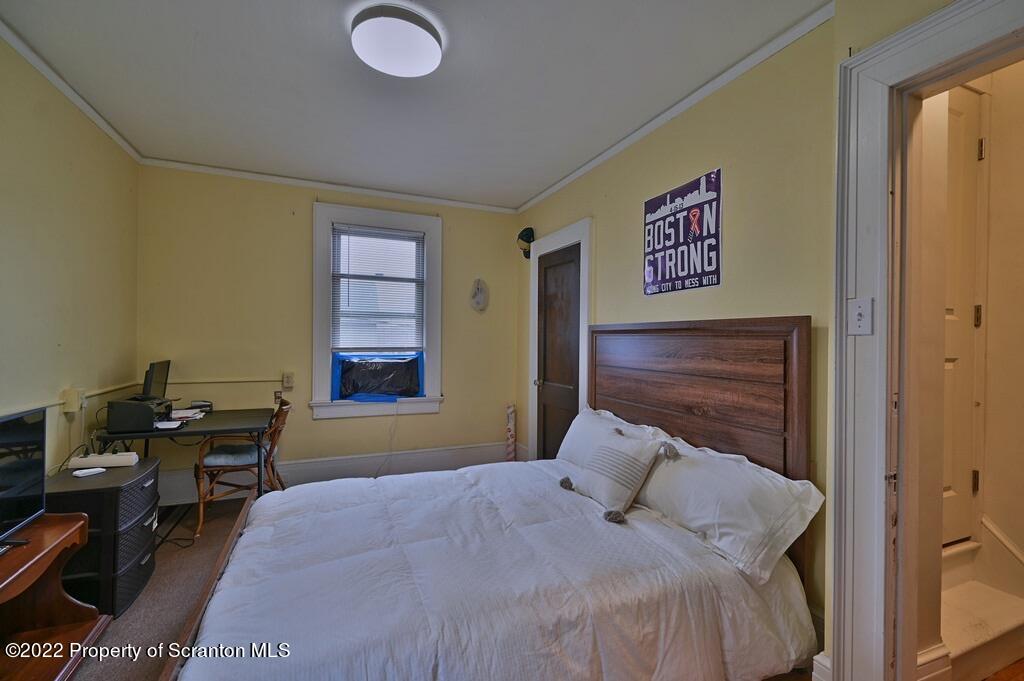811 Olive Street Scranton, PA 18510 - Photo 30 of 54 a bedroom with a bed and a desk