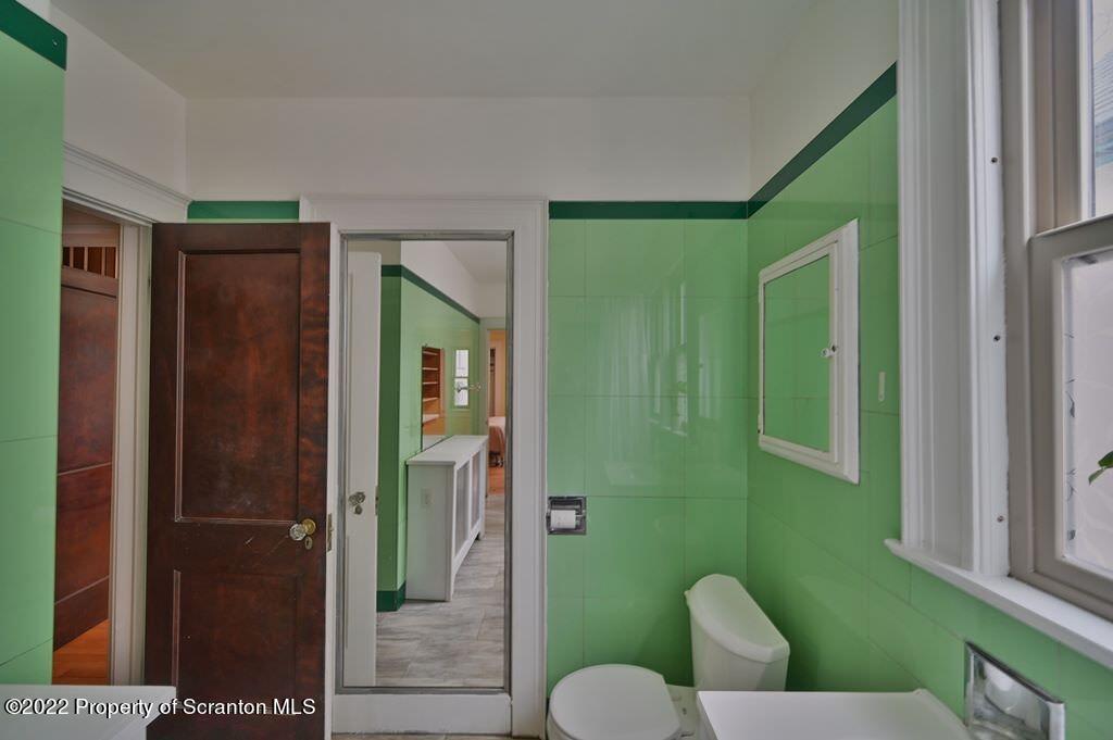 811 Olive Street Scranton, PA 18510 - Photo 35 of 54 a bathroom with a sink mirror and toilet
