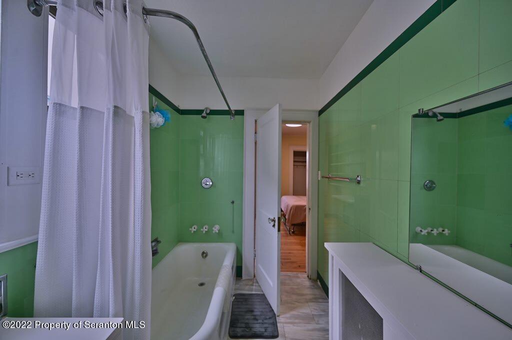 811 Olive Street Scranton, PA 18510 - Photo 36 of 54 a bathroom with a green shower and a sink