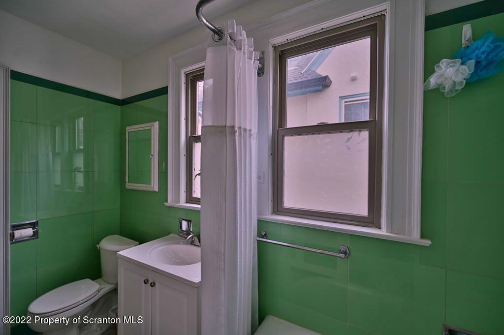 811 Olive Street Scranton, PA 18510 - Photo 38 of 54 a bathroom with a sink mirror toilet and shower