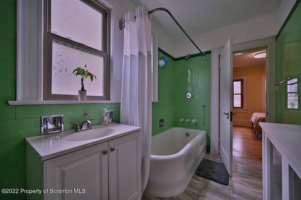 811 Olive Street Scranton, PA 18510 - Photo 39 of 54 a bathroom with a sink a bathtub and a mirror