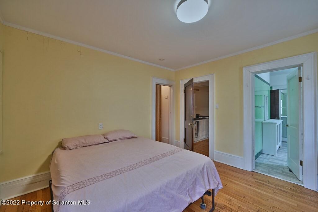 811 Olive Street Scranton, PA 18510 - Photo 41 of 54 a bedroom with a bed and wooden floor
