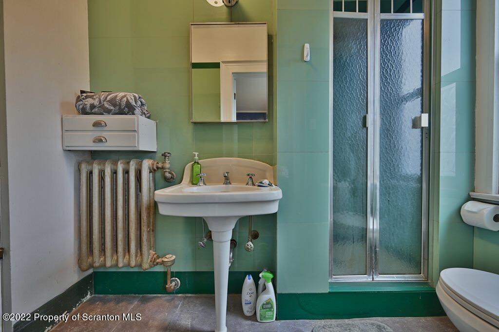 811 Olive Street Scranton, PA 18510 - Photo 44 of 54 a bathroom with a sink a toilet and shower