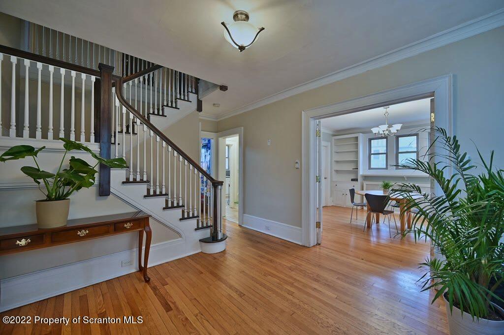 811 Olive Street Scranton, PA 18510 - Photo 5 of 54 a view of a hallway with wooden floor and stairs