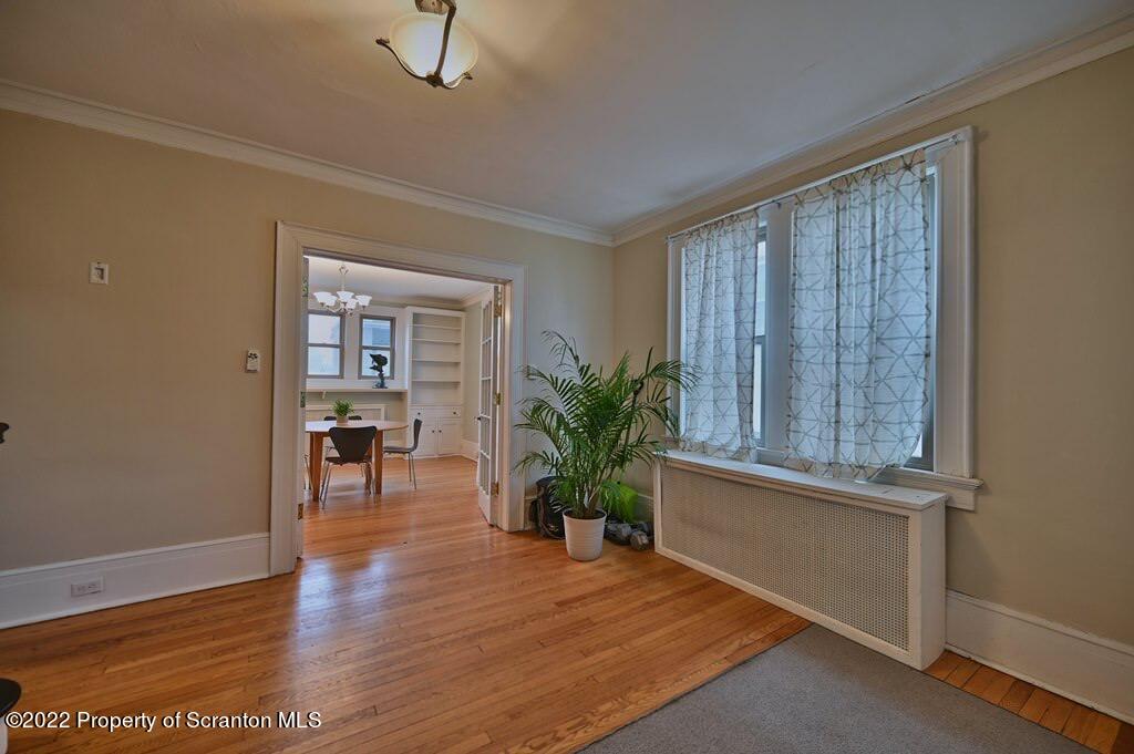 811 Olive Street Scranton, PA 18510 - Photo 6 of 54 an empty room with wooden floor and windows