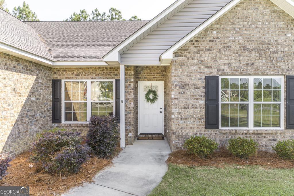 609 Live Oak Way Dublin, GA 31021 - Photo 7 of 37 a front view of a house with garden