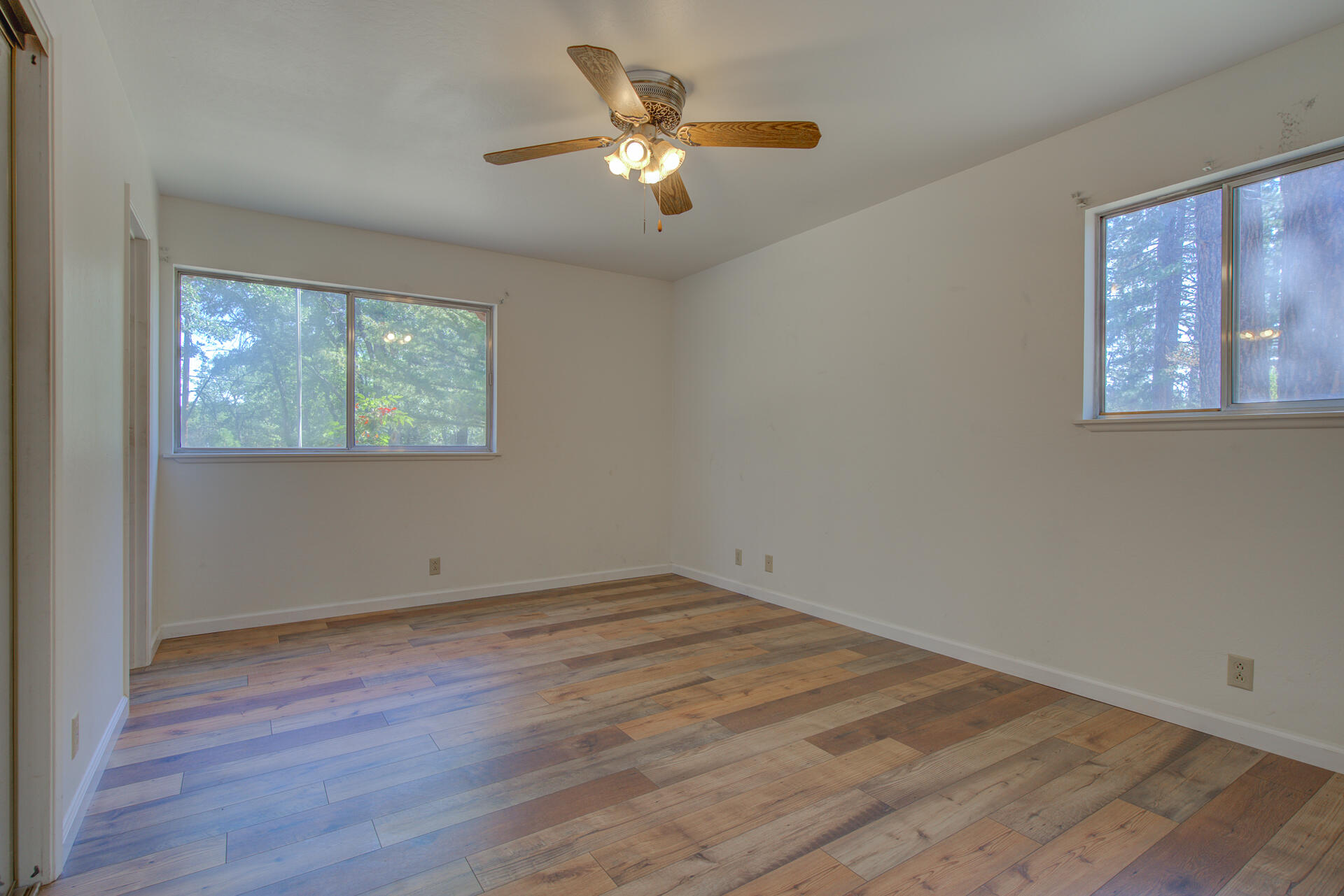 21694 Cassel Road Cassel, CA 96016 - Photo 34 of 65 a view of an empty room with wooden floor and a window