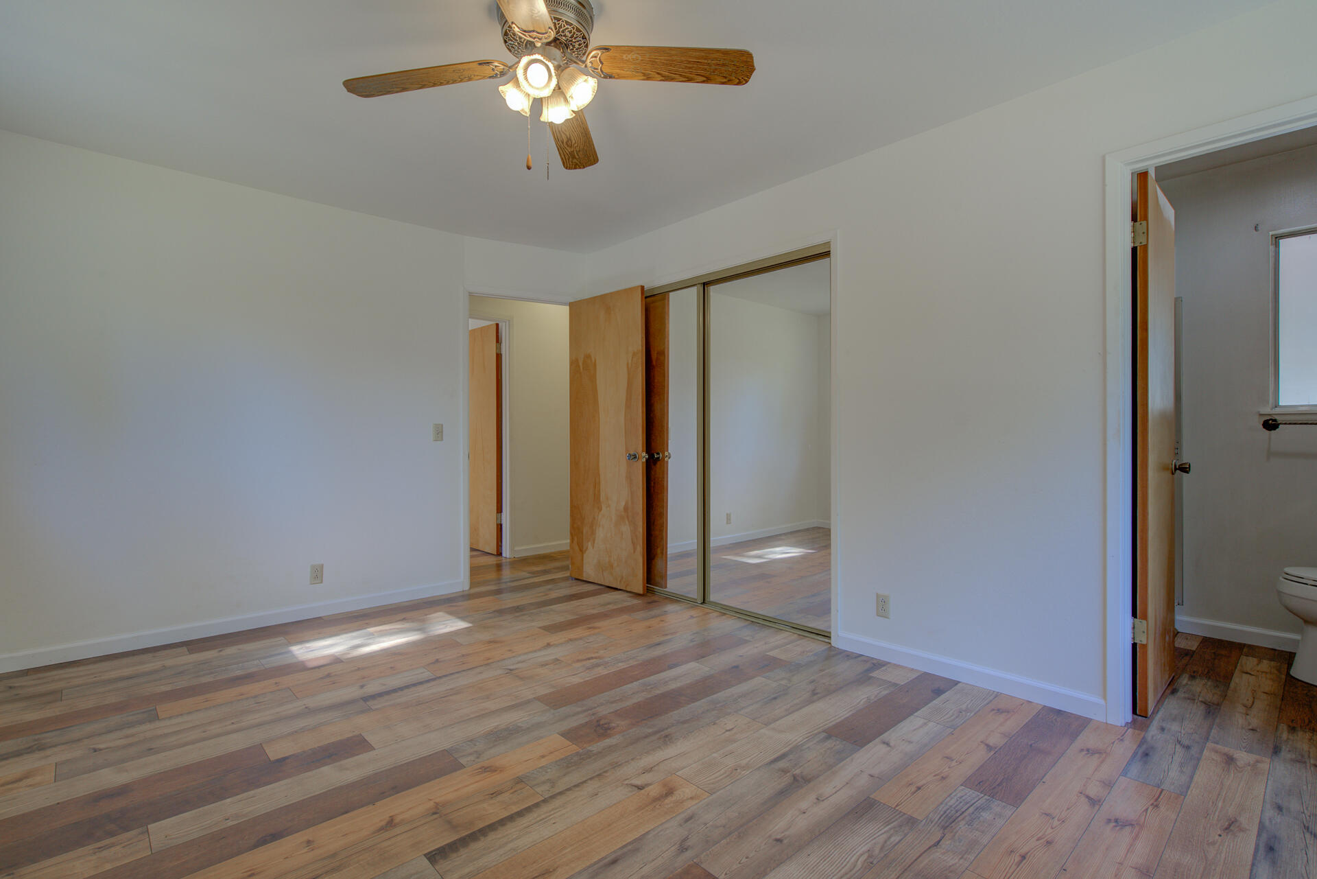 21694 Cassel Road Cassel, CA 96016 - Photo 36 of 65 an empty room with wooden floor and windows