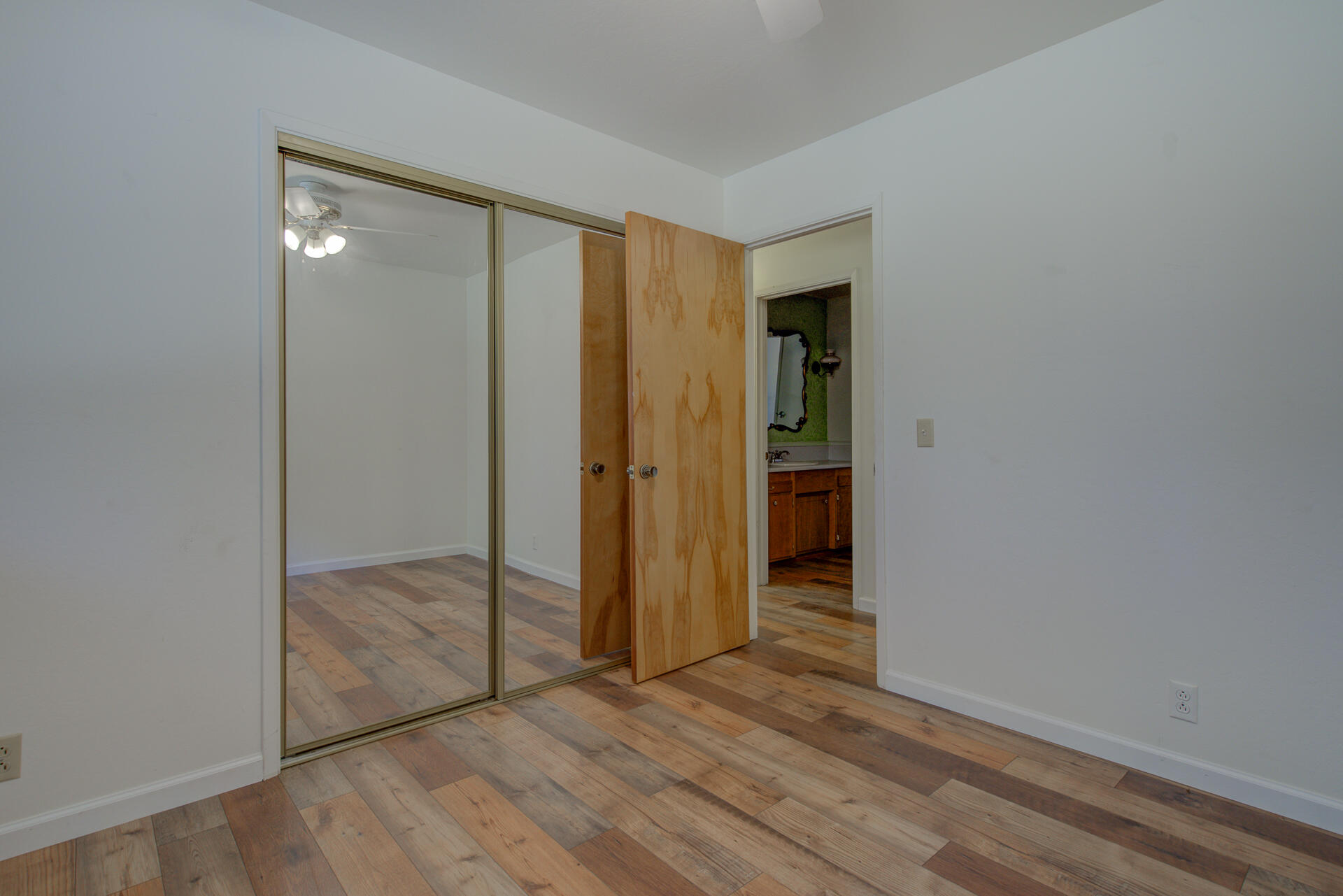 21694 Cassel Road Cassel, CA 96016 - Photo 40 of 65 an empty room with wooden floor and sliding door