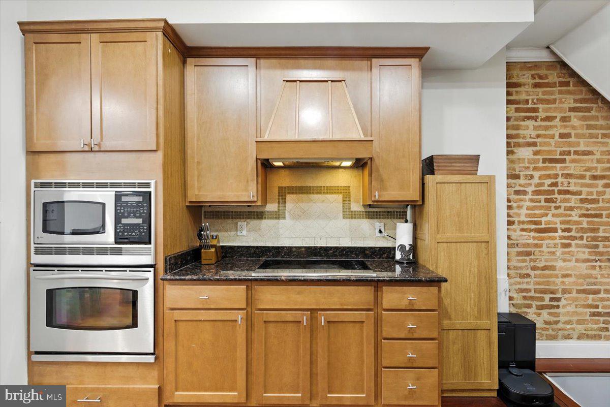 1711 South Hanover Street Baltimore, MD 21230 - Photo 12 of 31 a kitchen with granite countertop cabinets and steel stainless steel appliances