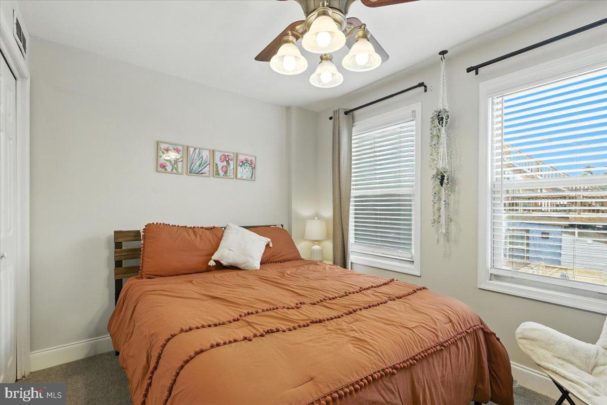 1711 South Hanover Street Baltimore, MD 21230 - Photo 16 of 31 a bedroom with a bed and a chandelier