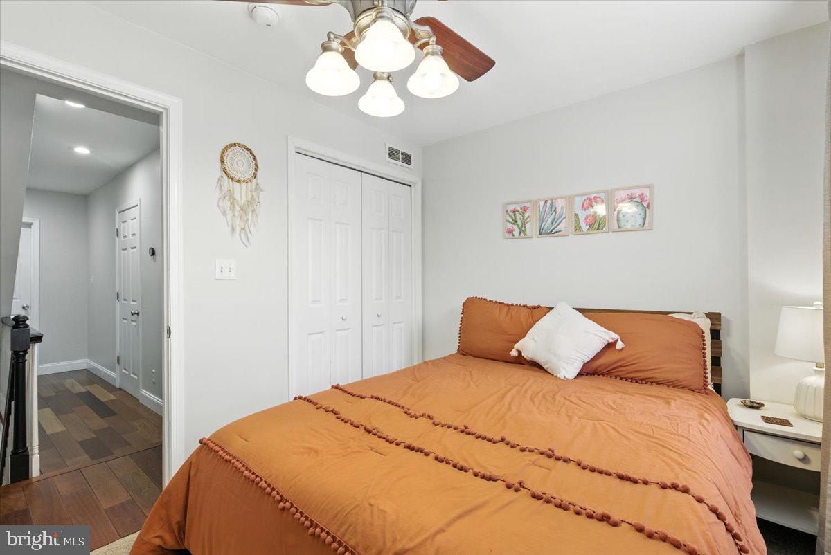 1711 South Hanover Street Baltimore, MD 21230 - Photo 17 of 31 a bedroom with a bed and a chandelier