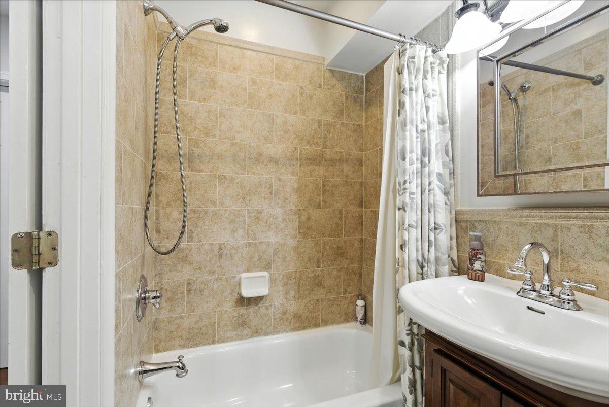 1711 South Hanover Street Baltimore, MD 21230 - Photo 19 of 31 a bathroom with a sink and a shower