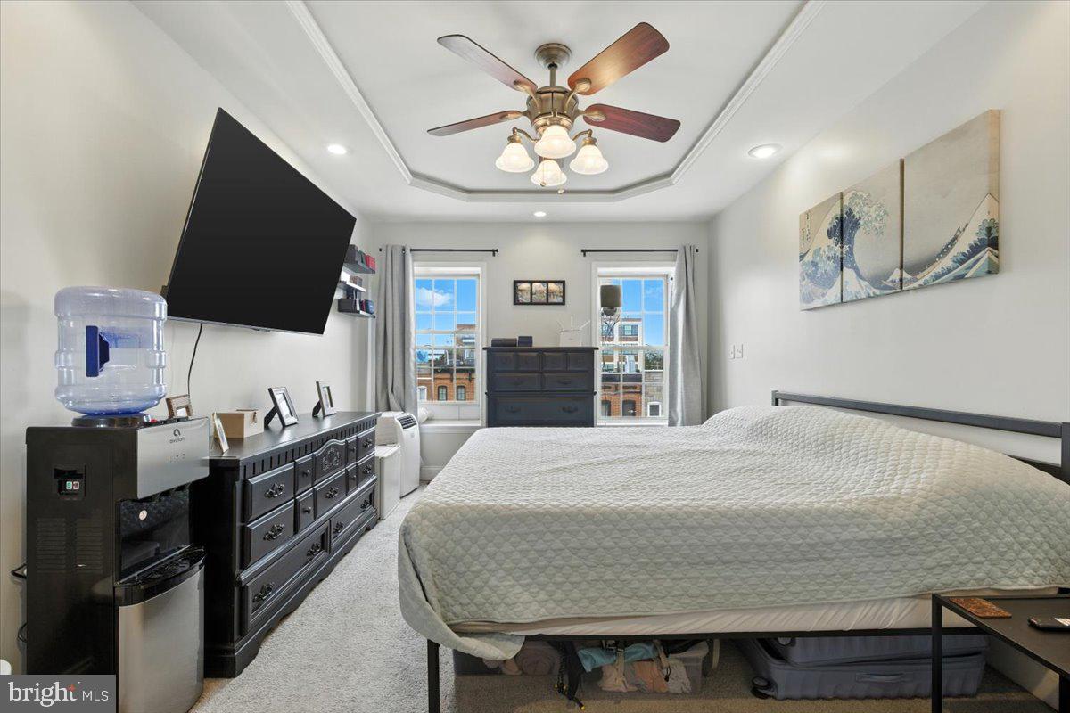 1711 South Hanover Street Baltimore, MD 21230 - Photo 21 of 31 a bedroom with a bed and a flat screen tv