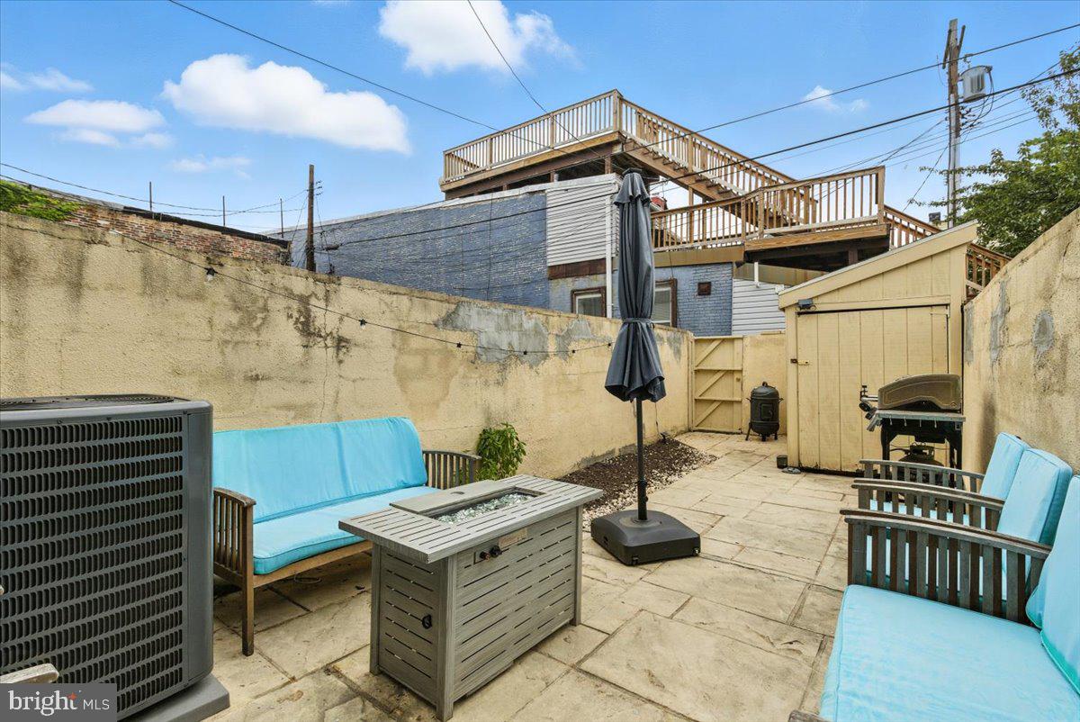 1711 South Hanover Street Baltimore, MD 21230 - Photo 30 of 31 a view of a patio with a table and chairs