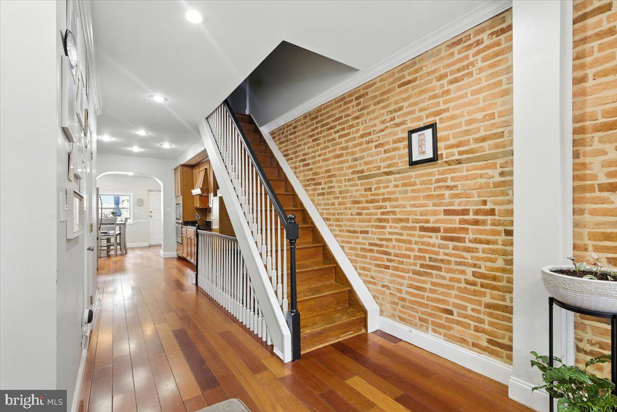 1711 South Hanover Street Baltimore, MD 21230 - Photo 4 of 31 a view of a hallway with wooden floor and staircase