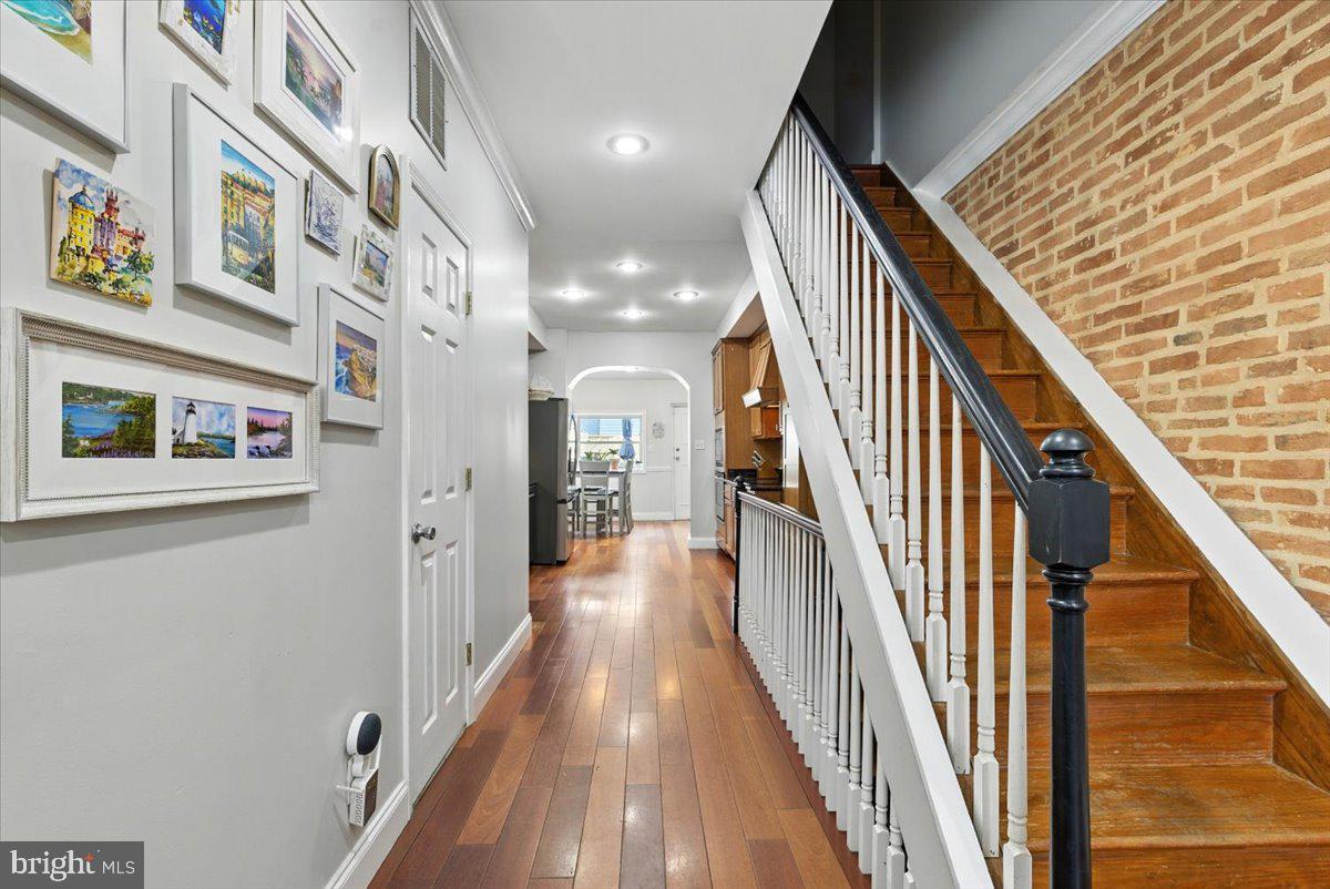 1711 South Hanover Street Baltimore, MD 21230 - Photo 5 of 31 a view of a hallway with paintings on the wall