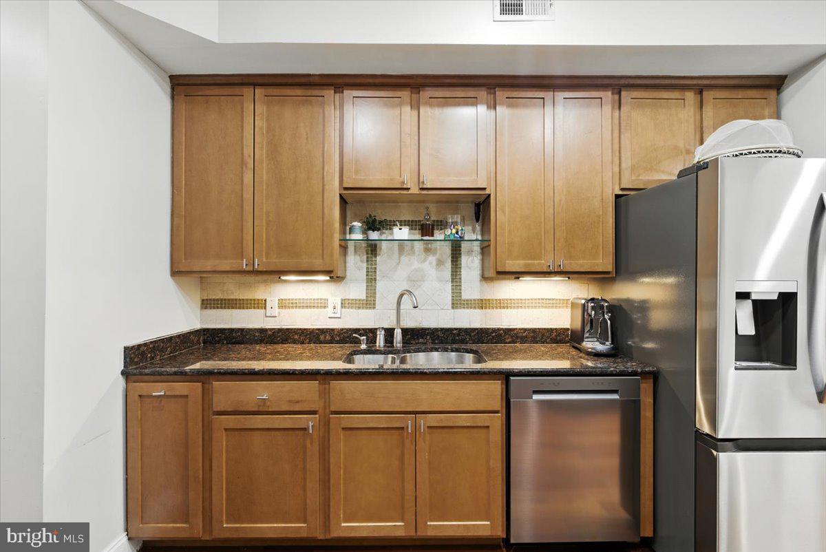 1711 South Hanover Street Baltimore, MD 21230 - Photo 10 of 31 a kitchen with stainless steel appliances granite countertop a sink a refrigerator and a granite counter tops