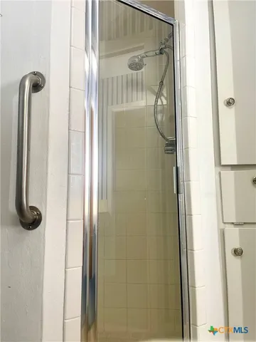 a bathroom with a glass shower door