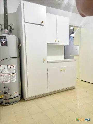a kitchen with a refrigerator and cabinets