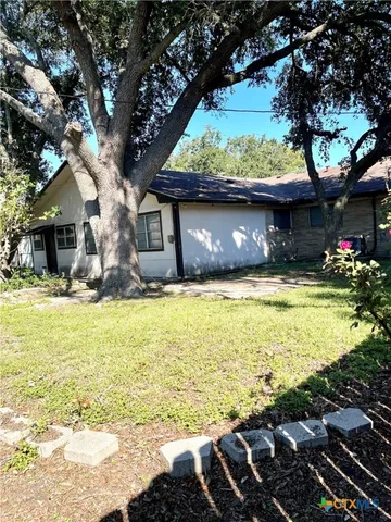 a swimming pool with outdoor seating and yard