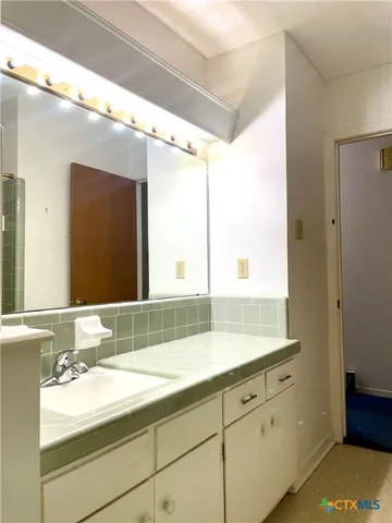 a bathroom with a sink and a mirror