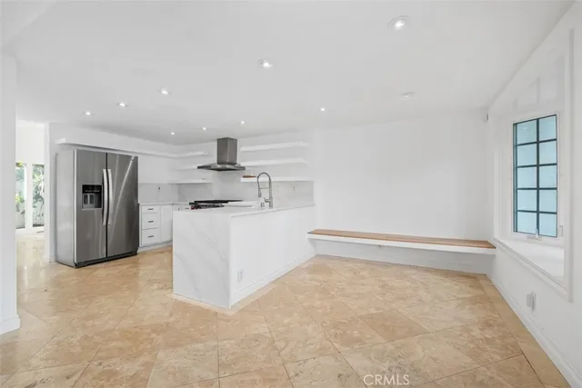 a kitchen with stainless steel appliances granite countertop a refrigerator sink and stove