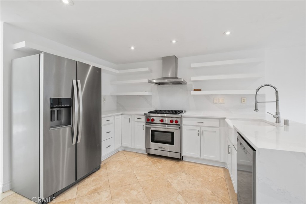 76 West Yale Loop Irvine, CA 92604 - Photo 4 of 11 a kitchen with stainless steel appliances granite countertop a refrigerator sink and stove