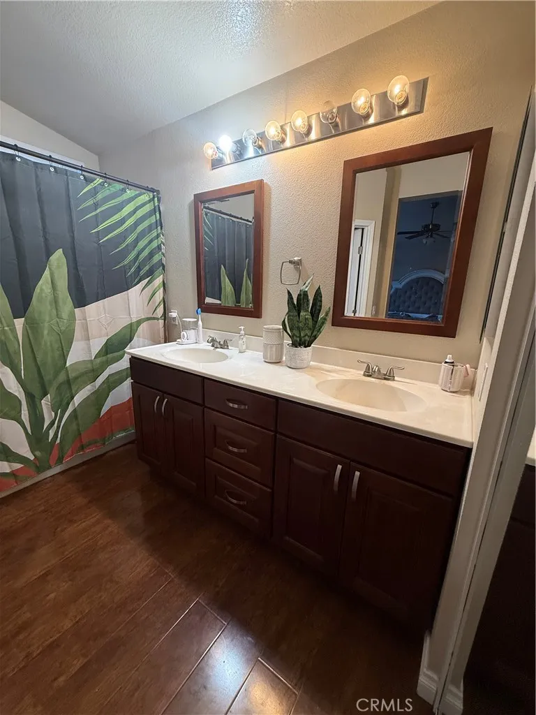 24809 Sweetgrass Court Murrieta, CA 92563 - Photo 1 of 1 a bathroom with a double vanity sink and a mirror