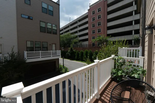a balcony with view of tall buildings and a street view
