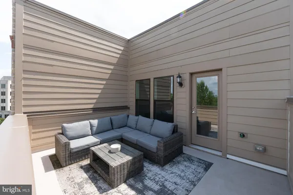 a view of a two chairs in the back yard of the house