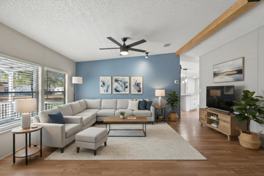 2744 Roy Sikes Road Hilliard, FL 32046 - Photo 15 of 97 a living room with furniture a flat screen tv and a large window