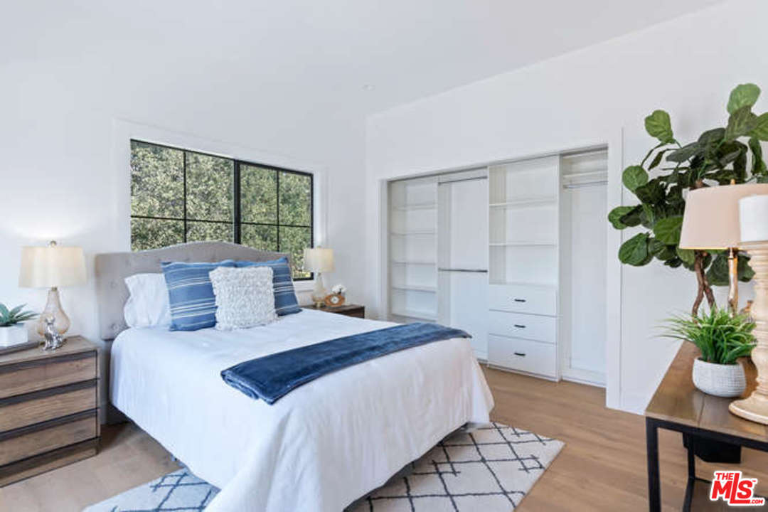 3628 Grayburn Road Pasadena, CA 91107 - Photo 17 of 25 a bedroom with a bed potted plant and a window