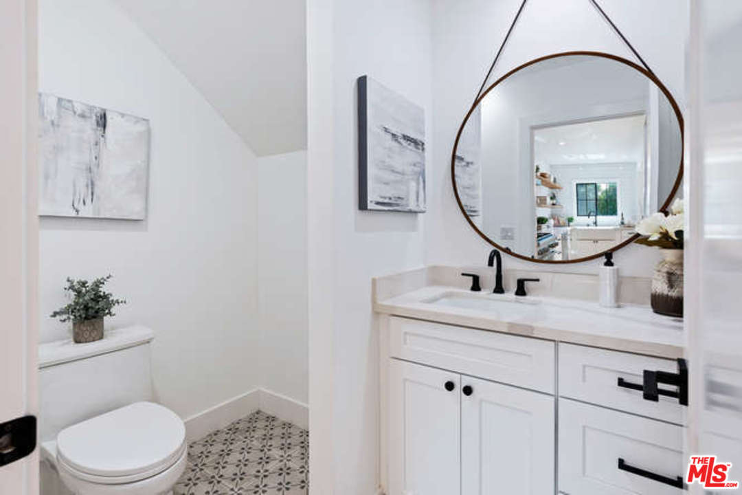 3628 Grayburn Road Pasadena, CA 91107 - Photo 22 of 25 a bathroom with a toilet a sink and mirror