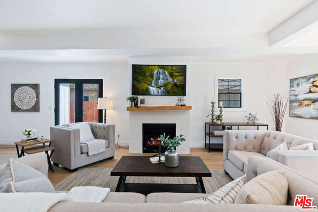 3628 Grayburn Road Pasadena, CA 91107 - Photo 6 of 25 a living room with furniture a fireplace a rug and a window