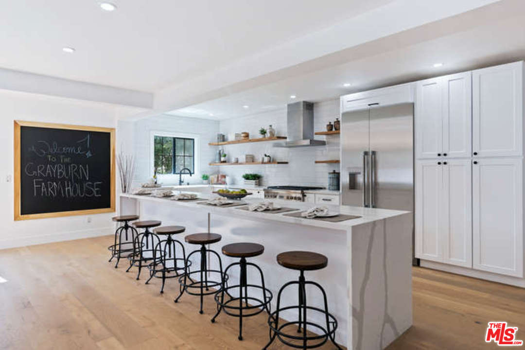 3628 Grayburn Road Pasadena, CA 91107 - Photo 7 of 25 a kitchen with stainless steel appliances granite countertop a table and chairs in it