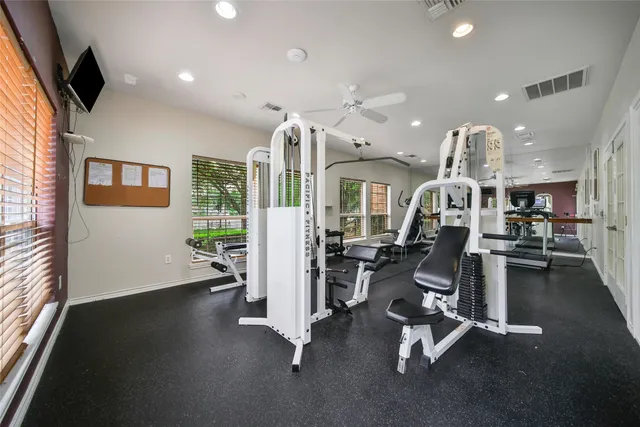 a view of house with wooden deck and outdoor seating