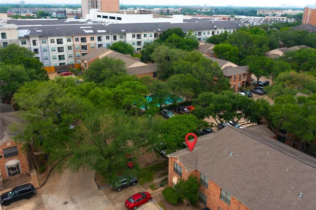 an aerial view of a house with a garden and swimming pool