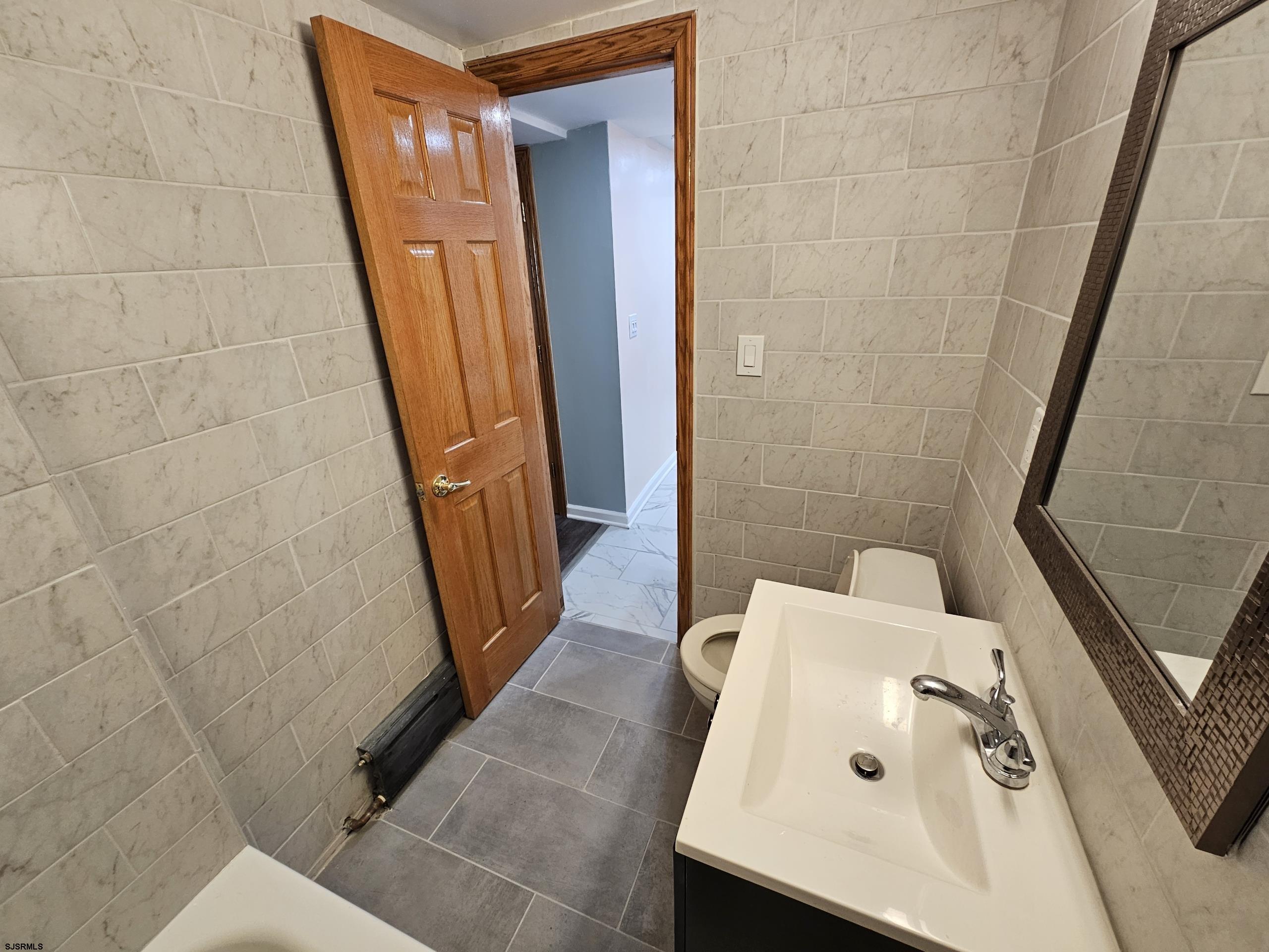 7 South Laclede Place, Unit 1 Atlantic City, NJ 08401 - Photo 17 of 21 a bathroom with a sink and a tub