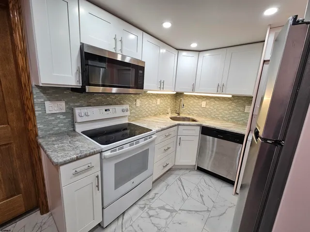 a kitchen with a sink stove and microwave