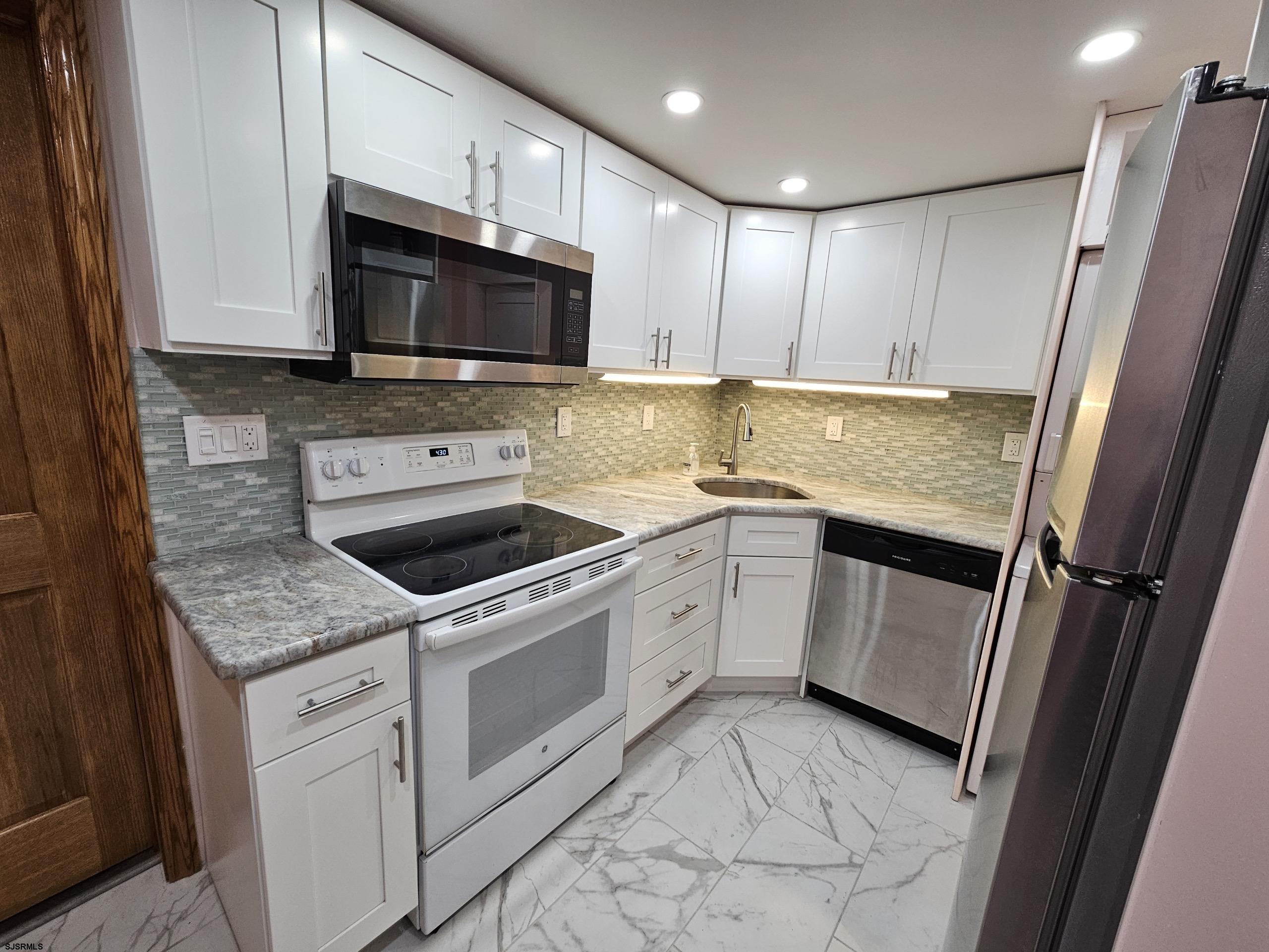 7 South Laclede Place, Unit 1 Atlantic City, NJ 08401 - Photo 8 of 21 a kitchen with a sink stove and microwave