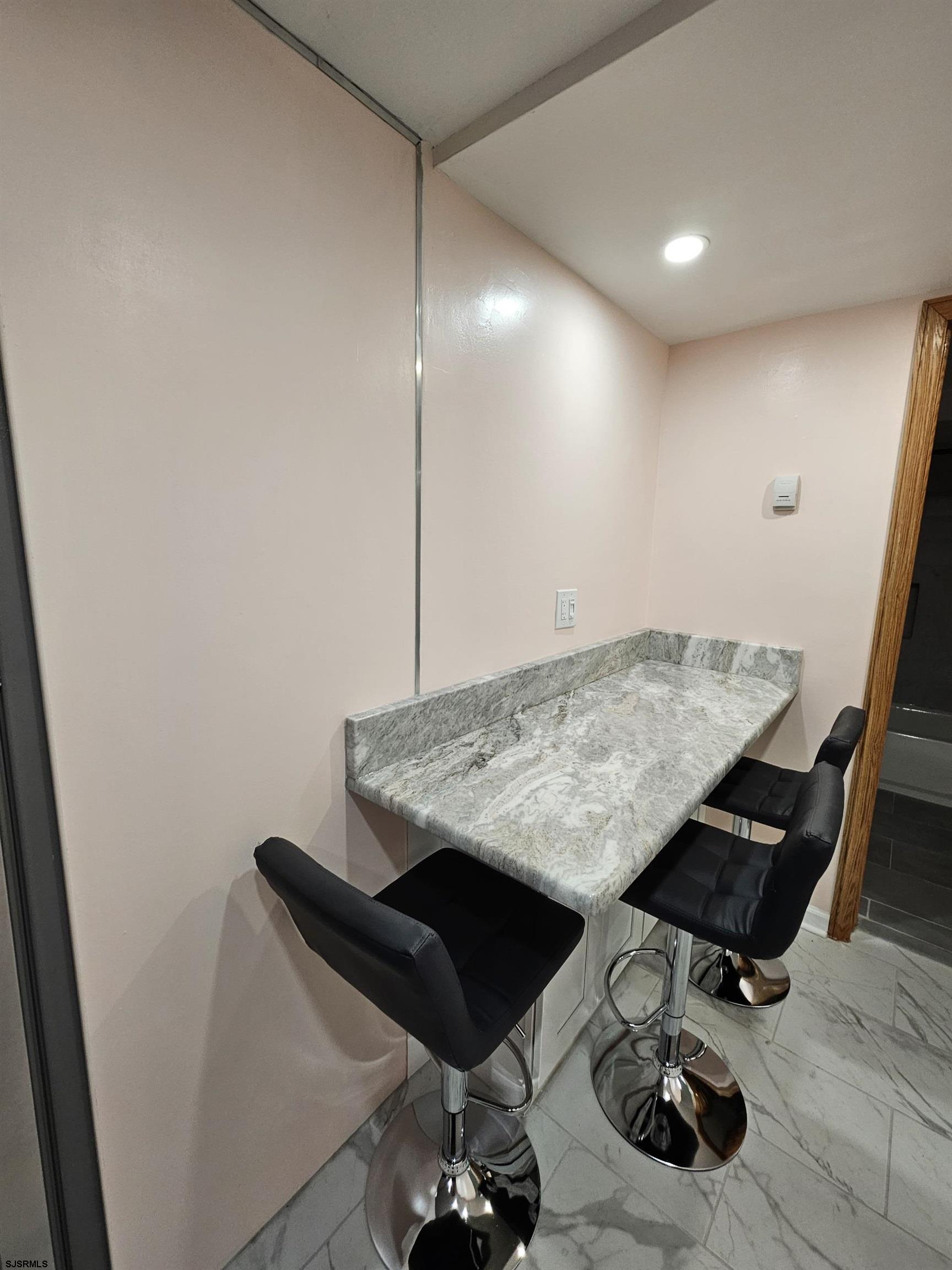 7 South Laclede Place, Unit 1 Atlantic City, NJ 08401 - Photo 10 of 21 a view of kitchen island with sink refrigerator and wooden floor