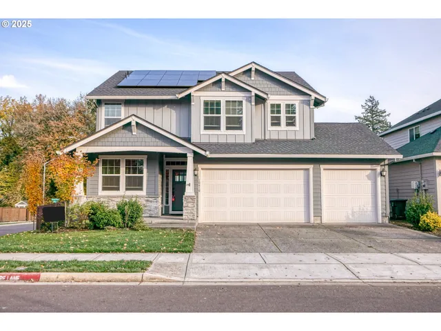 a front view of a house with a yard and a garage