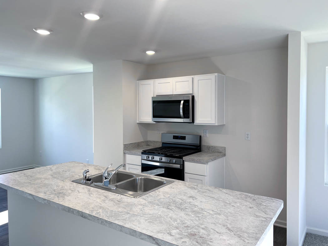 6740 Linden Trail, Unit D Wonder Lake, IL 60097 - Photo 3 of 55 a kitchen with granite countertop a sink a counter top space appliances and cabinets