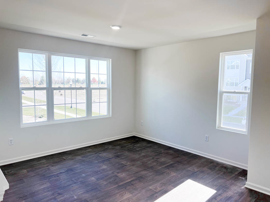 6740 Linden Trail, Unit D Wonder Lake, IL 60097 - Photo 5 of 55 an empty room with wooden floor and windows